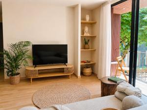 a living room with a flat screen tv on a stand at Terra Clara Studios & Apartments in Esposende