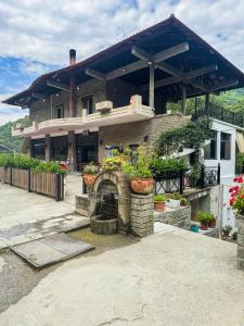 a house with a stone oven in front of it at Ambra & Arber Hotel in Bogovë