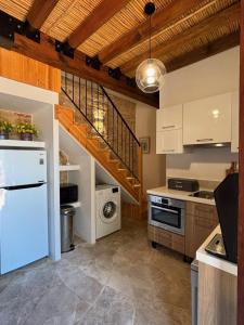 a kitchen with white appliances and a staircase at Arsos Nest in Arsos
