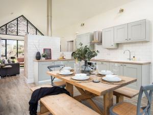 a kitchen and dining room with a wooden table at Summerset Lodge in Bamburgh
