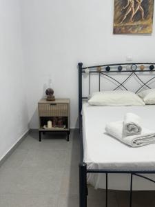 a bedroom with a bed and a side table at Sykano Espace, Skyros Island in Skiros