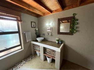 a bathroom with a sink and a mirror at Kulilo Lodge in Thabazimbi