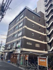 a large building with bikes parked in front of it at 四季安々2号店 in Kawaguchi