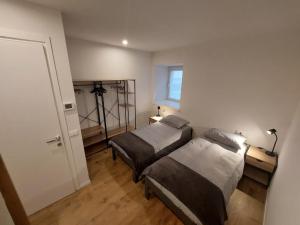 a bedroom with two beds and a window at Appartamento ZUFALL in Cogolo