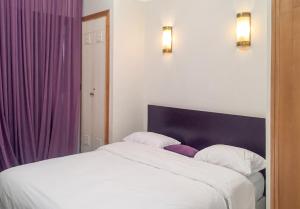 a bedroom with a large bed with purple curtains at Elegant Villa in Marrakech with a Private Pool. in Douar bel Rhanodour
