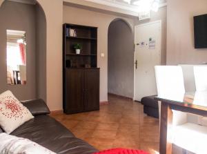 a living room with a couch and a book shelf at Comfortable Apartment Ayamonte Garden in Ayamonte