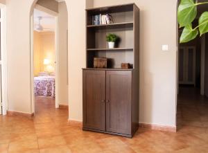 a large wooden book shelf in a room at Comfortable Apartment Ayamonte Garden in Ayamonte +27 photos