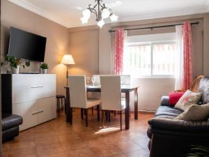 a living room with a table and a couch at Comfortable Apartment Ayamonte Garden in Ayamonte