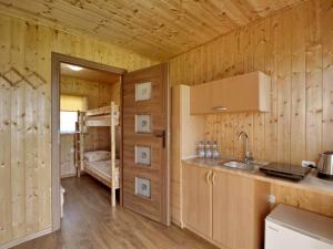 a kitchen with a sink and a bunk bed at Pelikan in Sianozety