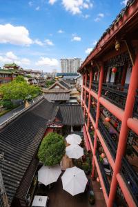 an overhead view of a building with umbrellas at Wenjun Courtyard Hotel Chengdu ,English-Speaking , Pick-up Service ,Laundry Service , Local Tours in Chengdu +166 photos