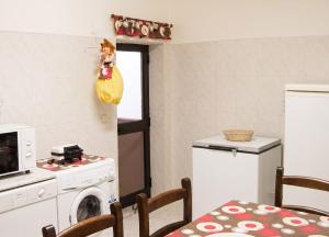 a kitchen with a washing machine and a microwave at Sea View Apartment in Peniche in Peniche