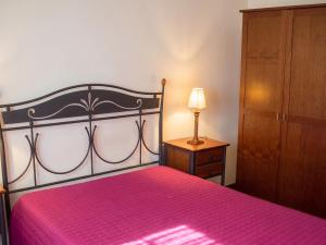 a bedroom with a bed and a dresser and a lamp at Sea View Apartment in Peniche in Peniche