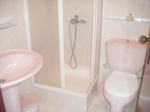 a bathroom with a shower and a toilet and a sink at Sea View Apartment in Peniche in Peniche +24 photos
