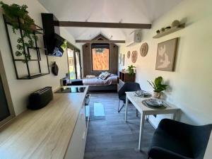a living room with a table and a couch at Nordsee Urlaubsparadies in Butjadingen