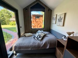 a bedroom with a bed with a large window at Nordsee Urlaubsparadies in Butjadingen