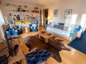 a living room with a couch and a table at Spacious Apartment in Lens with Mountain View in Lens