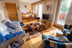 a living room with a couch and a table at Spacious Apartment in Lens with Mountain View in Lens