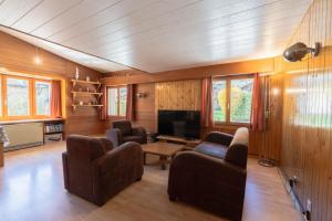 a living room with couches and a television at Malgré tout 2 in Salvan