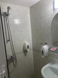 a bathroom with a shower and a toilet and a sink at Family Hotel Markony in Pamporovo +55 photos