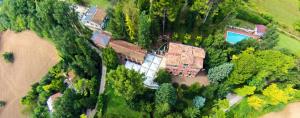 an aerial view of a house with a swimming pool at Comfortable Apartment in Fabriano, 35 m² with Shared Pool in Fabriano