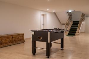 a foosball table in a room with stairs at Bartl Apartments in Rottach-Egern