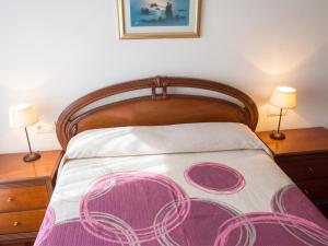 a bedroom with a bed with two night stands and two lamps at Charming Apartment in El Grove, Sea View in O Grove