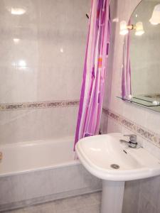a bathroom with a sink and a bath tub at Charming Apartment in El Grove, Sea View in O Grove +19 photos