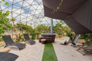 a patio with chairs and a glass greenhouse at Quinta da Amora in Quinta do Anjo +28 photos