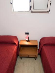 a room with two beds and a table with a lamp at Charming Apartment in Pisciotta with Terrace and Parking in Pisciotta +10 photos
