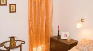 a room with a bed and a table and a curtain at Chic apartment in Tolva, mountain view, 75 m², fireplace in Tolva