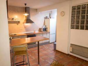 a kitchen with a table and a refrigerator at Chic apartment in Tolva, mountain view, 75 m², fireplace in Tolva