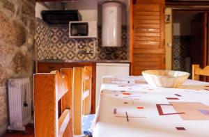 a kitchen with a table with paper on it at Comfortable Apartment in Seia with Terrace and Fireplace in Seia