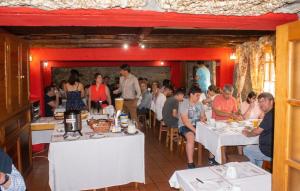 a group of people sitting at tables in a restaurant at Comfortable Apartment in Seia with Terrace and Fireplace in Seia +3 photos