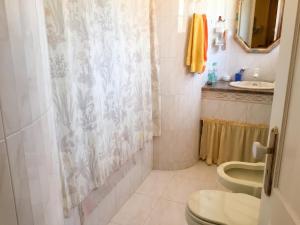 a bathroom with a toilet and a sink at Charming Apartment in Sintra with Pool in Sintra