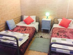 a room with two beds and a table with a lamp at Charming Apartment in Sintra with Pool in Sintra +7 photos