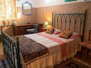 a bedroom with a bed with a metal frame at Charming Apartment in Sintra with Pool in Sintra