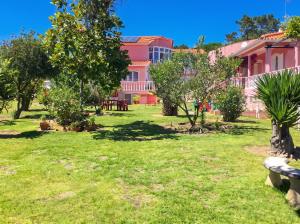 a pink building with trees in a yard at Charming Apartment in Sintra with Pool in Sintra