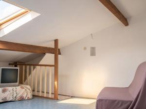 a attic room with a bed and a tv at Appartement avec vue sur mer à Port-Vendres, 60 m², balcons. in Port-Vendres +16 photos