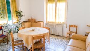 a living room with a table and a couch at Spacious Apartment in Pescara, 120 m², Ideal for Families in Pescara