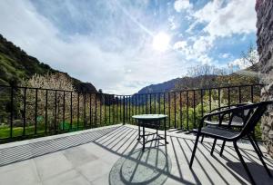 a patio with two chairs and a table on a balcony at Musa Hotel in Yeghegis