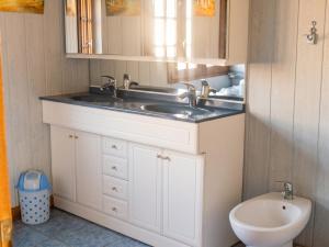 a bathroom with a sink and a toilet at Charmante maison avec piscine privée à Orsanco - 70 m² in Orsanco