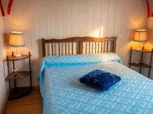 a bedroom with a bed with a blue blanket and two lamps at Charmante maison avec piscine privée à Orsanco - 70 m² in Orsanco +4 photos