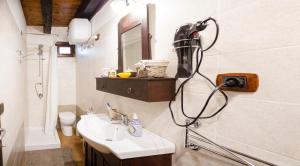 a bathroom with a sink and a blow dryer on the wall at Modern Apartment near Arce City Centre, 62 m², Parking in Arce