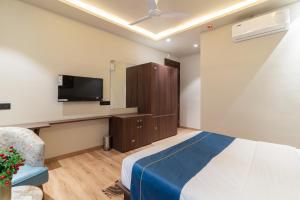 a hotel room with a bed and a tv at The Grand Dularia in Nagpur +27 photos