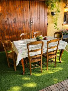 a wooden table and chairs with a table at Appartement in Courthézon