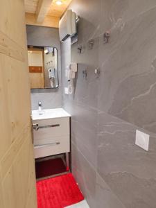 a bathroom with a sink and a mirror at Studio chaleureux à Aime la Plagne 25 m² en montagne in Aime-La Plagne