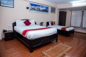 a bedroom with two beds in a room at UNPLAN Kathmandu in Kathmandu