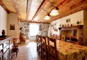 a kitchen and dining room with a table and chairs at Maison confortable avec vue sur la montagne à Le Fau in Le Fau