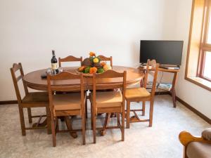 a dining room with a table with fruit on it at Spacious Apartment in Espinho with Fireplace, 87 sqm in Espinho