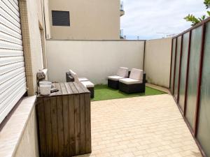 a patio with two chairs and a table on a balcony at Spacious Apartment in Espinho with Fireplace, 87 sqm in Espinho